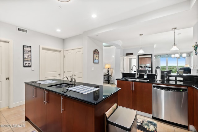 kitchen featuring hanging light fixtures, sink, stainless steel dishwasher, and an island with sink