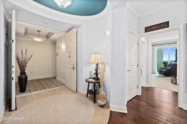 foyer entrance featuring ornamental molding and hardwood / wood-style floors