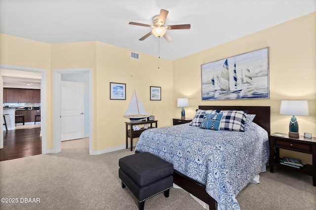 bedroom with ceiling fan and light colored carpet