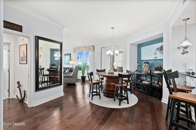 dining area featuring ornamental molding, dark wood-type flooring, and a chandelier