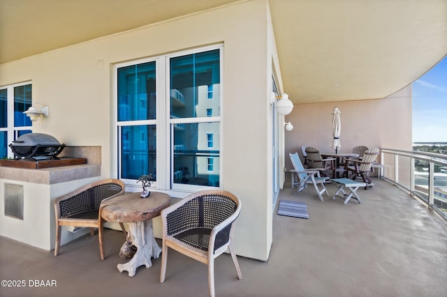 view of patio featuring a balcony and grilling area