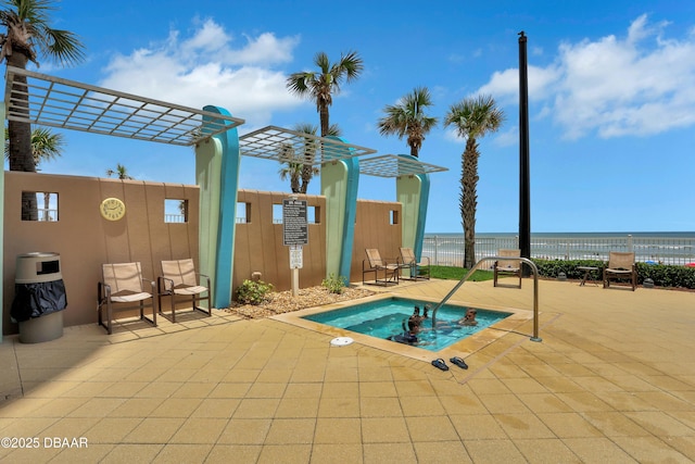 view of swimming pool featuring a water view and a patio