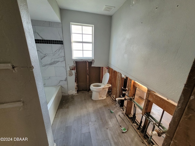 223 Clark Pl, Port Orange, FL 32127 - full bathroom with a textured wall, visible vents, toilet, and wood finished floors