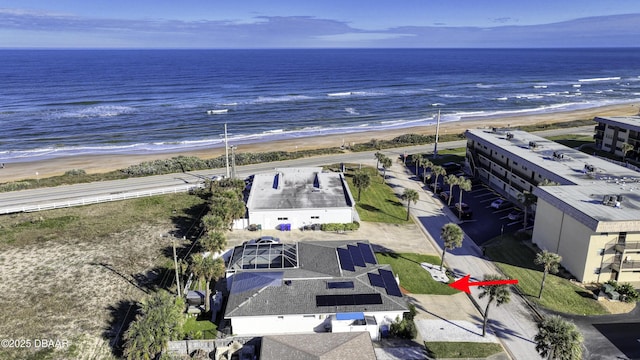 aerial view with a water view and a beach view