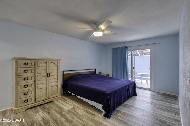 bedroom featuring a textured ceiling, ceiling fan, light hardwood / wood-style flooring, and access to outside