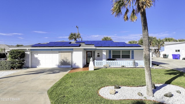 ranch-style house with a garage, a front yard, solar panels, and covered porch