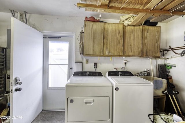 laundry area with cabinets and washing machine and dryer