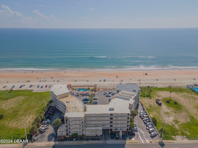 bird's eye view featuring a water view and a beach view