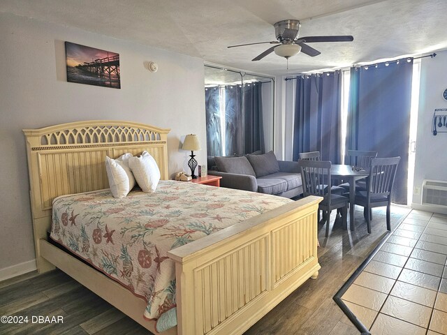 1233 S Atlantic Ave Unit 5270, Daytona Beach, FL 32118 - bedroom featuring a ceiling fan, dark wood-style flooring, and a textured ceiling