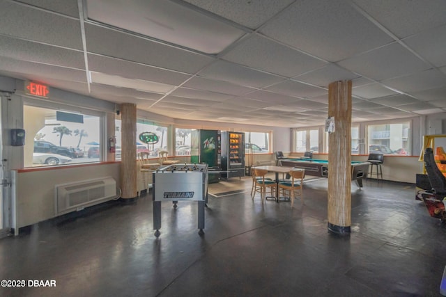 recreation room featuring a wall mounted air conditioner, billiards, and a drop ceiling