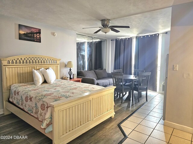 1233 S Atlantic Ave Unit 5270, Daytona Beach, FL 32118 - bedroom with a textured ceiling, wood finished floors, a ceiling fan, and baseboards