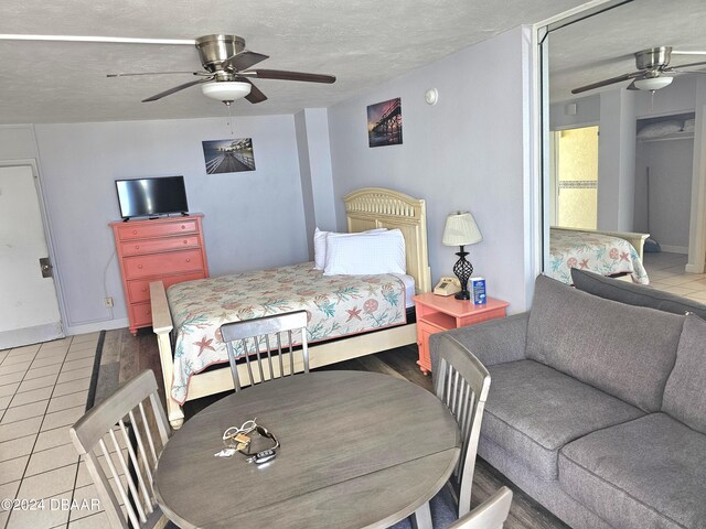 1233 S Atlantic Ave Unit 5270, Daytona Beach, FL 32118 - bedroom with light tile patterned floors, baseboards, a ceiling fan, and a textured ceiling