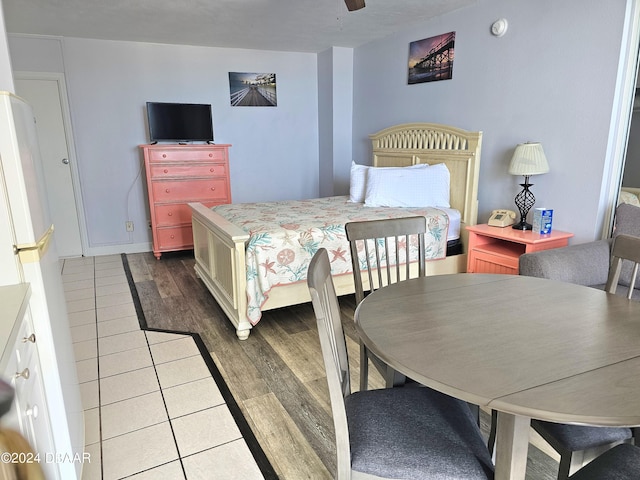 1233 S Atlantic Ave Unit 5270, Daytona Beach, FL 32118 - bedroom featuring wood finished floors, freestanding refrigerator, and ceiling fan