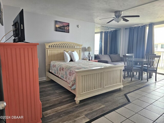1233 S Atlantic Ave Unit 5270, Daytona Beach, FL 32118 - bedroom featuring a textured ceiling, access to outside, dark wood-style flooring, and a ceiling fan