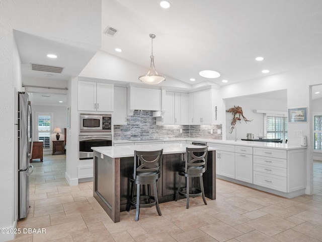 1601 S Riverside Dr, Edgewater, FL 32132 - kitchen with stainless steel appliances, tasteful backsplash, white cabinets, and recessed lighting