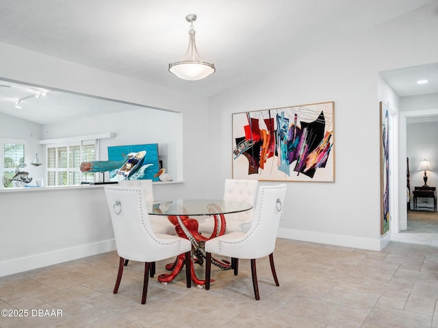 1601 S Riverside Dr, Edgewater, FL 32132 - dining area featuring baseboards, track lighting, and lofted ceiling