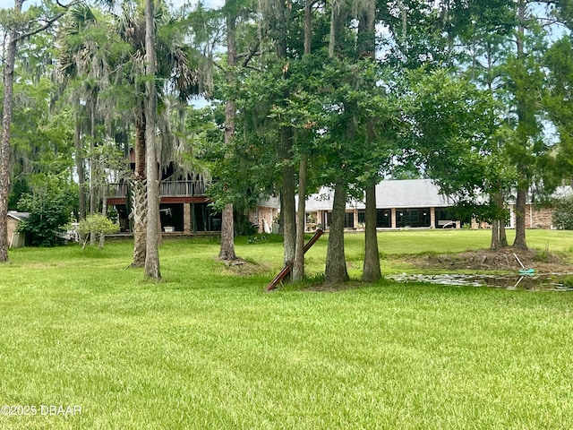 11 Winchester Rd, Ormond Beach, FL 32174 - view of green lawn featuring a deck