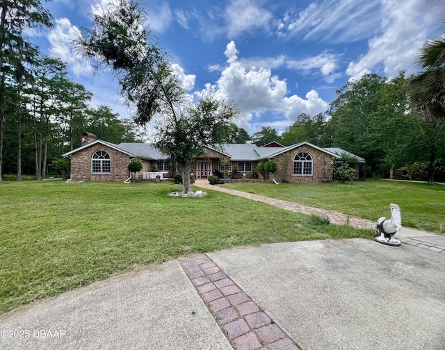 11 Winchester Rd, Ormond Beach, FL 32174 - view of front of home featuring a chimney and a front yard