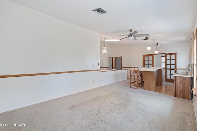 350 Citrus Club Dr, Merritt Island, FL 32953 - spare room with light carpet, a ceiling fan, and french doors