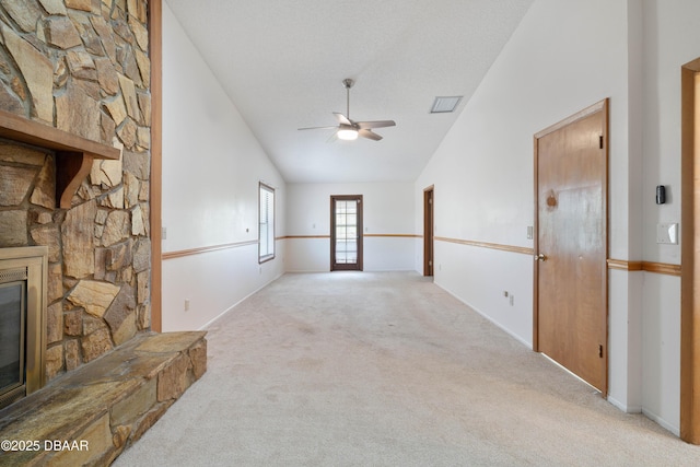 350 Citrus Club Dr, Merritt Island, FL 32953 - unfurnished living room with carpet flooring, ceiling fan, high vaulted ceiling, and a stone fireplace