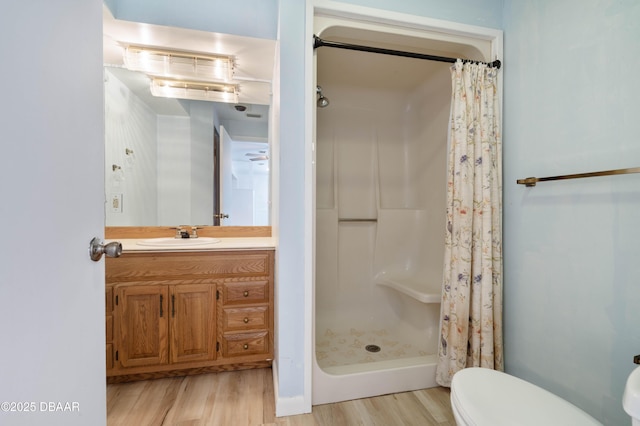 350 Citrus Club Dr, Merritt Island, FL 32953 - bathroom with wood finished floors, a stall shower, toilet, and vanity