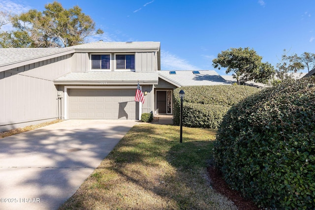 view of front of home with a garage and a front lawn