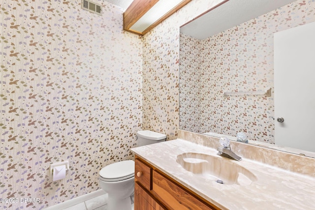 bathroom with vanity, tile patterned floors, and toilet