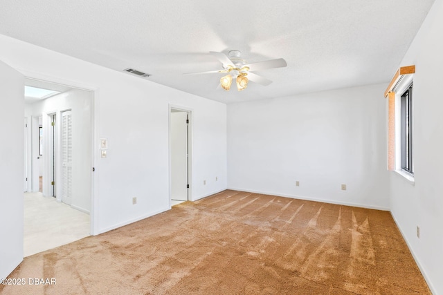 spare room with carpet floors and ceiling fan