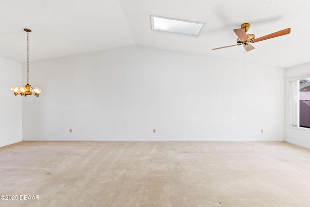 carpeted empty room with lofted ceiling and ceiling fan with notable chandelier