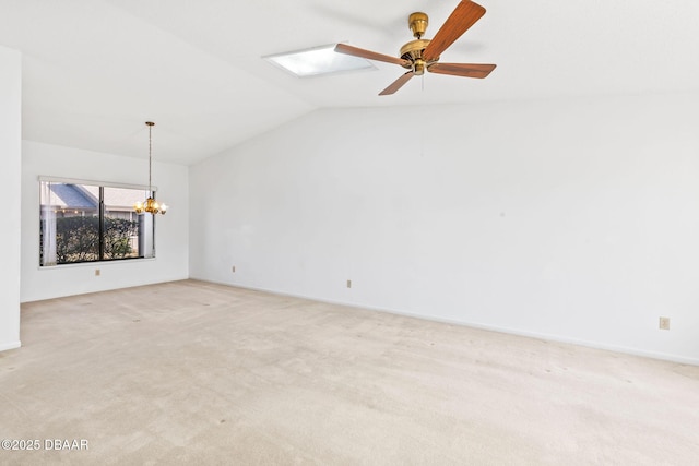 carpeted empty room featuring vaulted ceiling and ceiling fan with notable chandelier