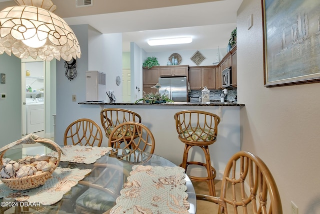 dining space featuring washing machine and clothes dryer