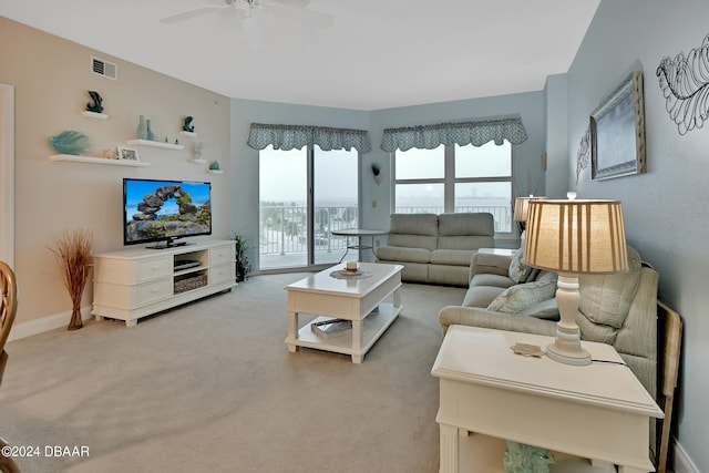 living room with light carpet and ceiling fan