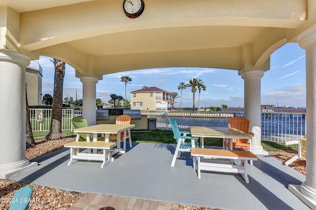 view of patio / terrace featuring area for grilling, a grill, and a water view