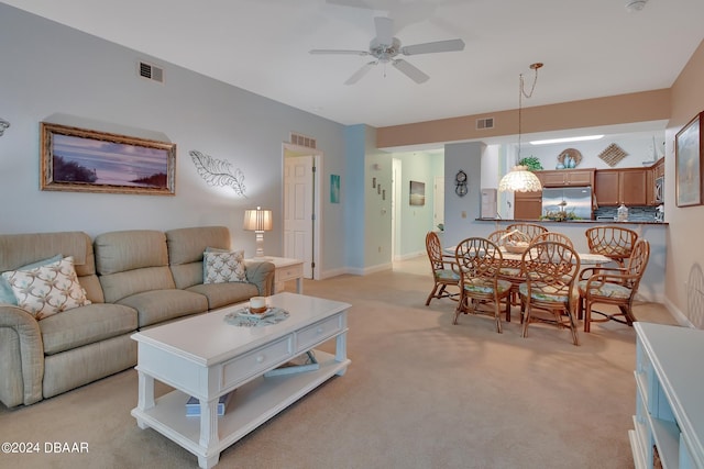 living room featuring light carpet and ceiling fan