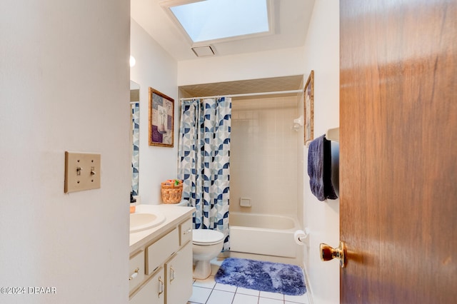 full bathroom with tile patterned floors, vanity, toilet, a skylight, and shower / bathtub combination with curtain