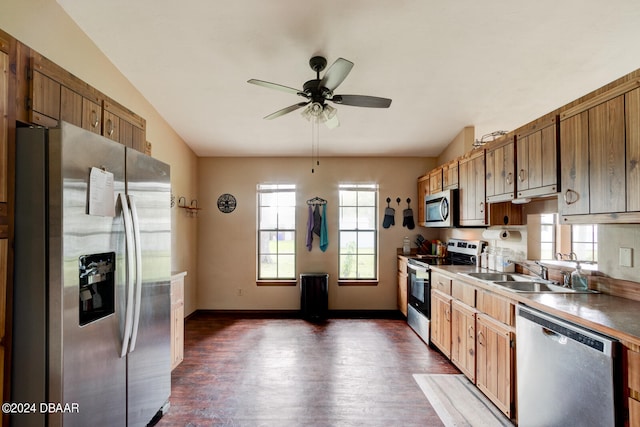 kitchen with stainless steel appliances, sink, ceiling fan, lofted ceiling, and dark wood-type flooring