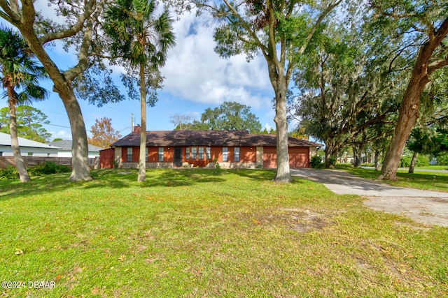 ranch-style house with a garage and a front yard