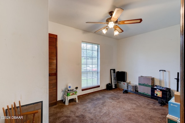 misc room with carpet flooring and ceiling fan