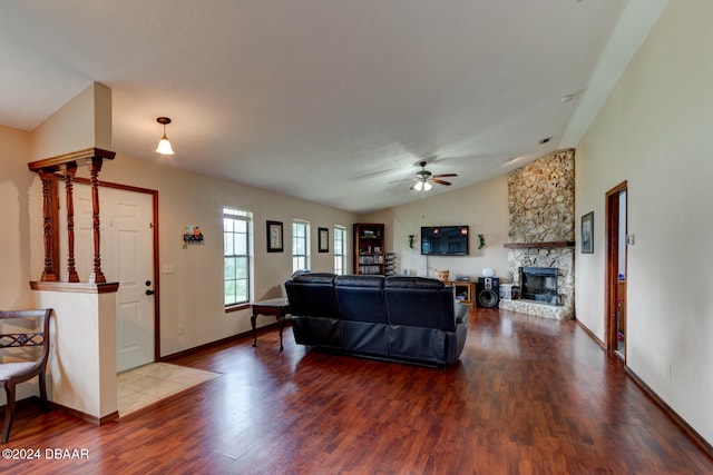 living room featuring hardwood / wood-style floors, a fireplace, lofted ceiling, and ceiling fan