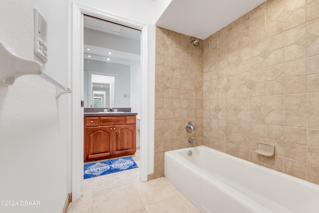 bathroom with tile patterned flooring, vanity, and tiled shower / bath combo