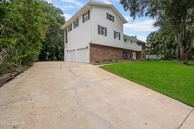 view of home's exterior featuring a lawn and a garage