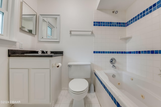 full bathroom with vanity, tile patterned flooring, tiled shower / bath, and toilet