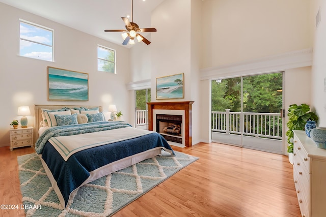 bedroom with high vaulted ceiling, access to outside, ceiling fan, and light hardwood / wood-style flooring