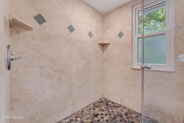 bathroom with a tile shower