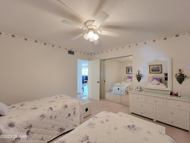 bedroom with ceiling fan, a textured ceiling, and a closet