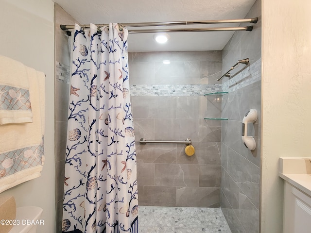 bathroom with walk in shower and vanity