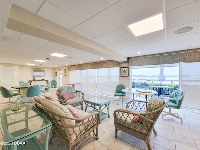 tiled living room with a drop ceiling