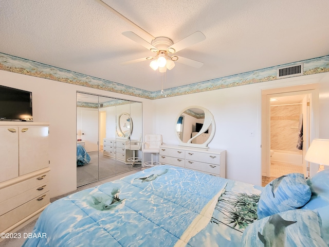 bedroom with a closet, a textured ceiling, and ceiling fan