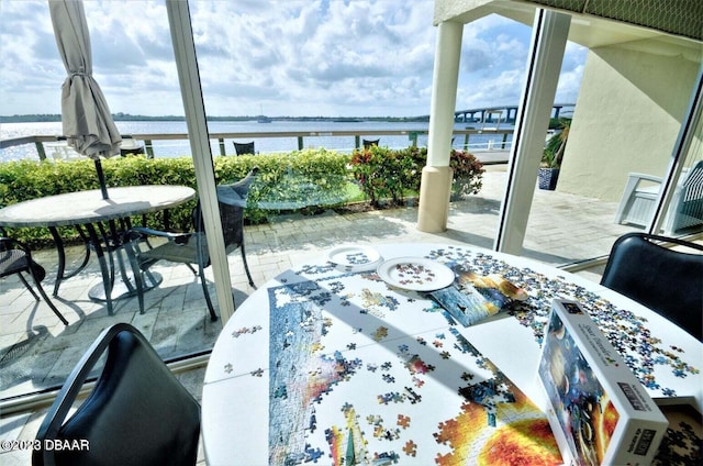 balcony featuring a patio area and a water view