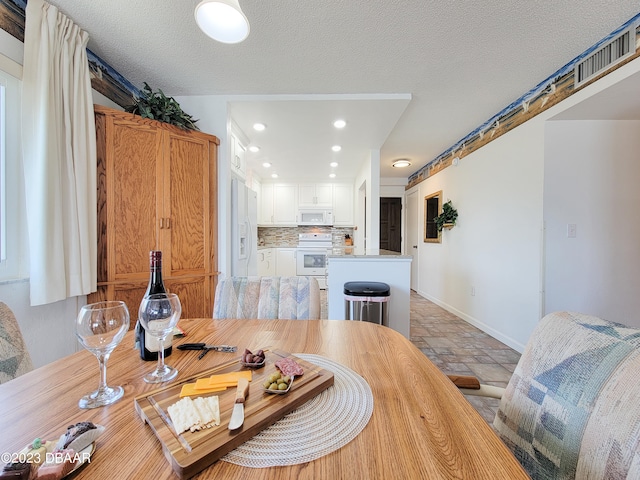 dining room featuring a textured ceiling